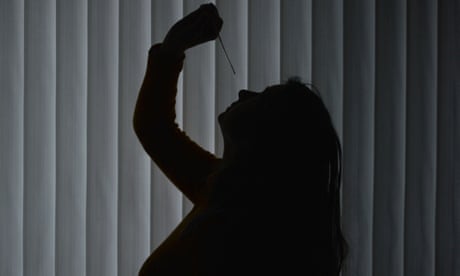 Stock photo of a woman taking a rapid antigen test
