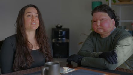 two people sit side by side at a table