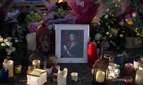 Floral tributes and candles surround a photograph of Ashling Murphy left at the Grand Canal in Tullamore, County Offaly.