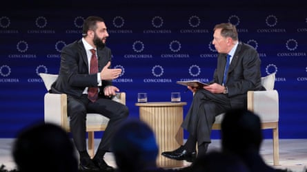 David Petraeus on stage talking to Sharaa