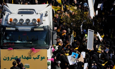 Mourners beside a truck