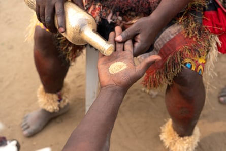 Powder is poured from a bottle into a hand