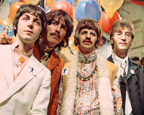 The Beatles in colorful patterned clothing stand beneath a ceiling of balloons in various colors
