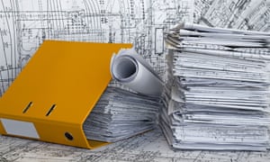 Yellow file folder and heap of design drawings