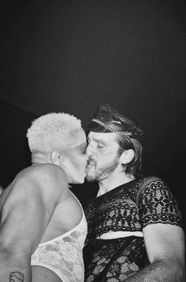 Black and white photograph of two people kissing