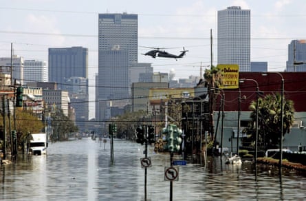 a helicopter flies over a flooded city