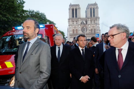 French Prime Minister Edouard Philippe, Minister of Culture Franck Riester and French President Emmanuel Macron gather near the Notre Dame Cathedral as its burns.