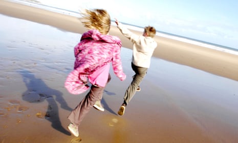 children skipping on a sunny beach