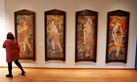 Four figurative embroidery panels in a row on a gallery wall