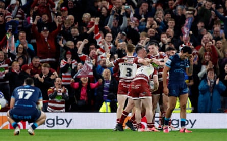 Wigan players huddle in celebration after beating Hull KR in the 2024 Grand Final