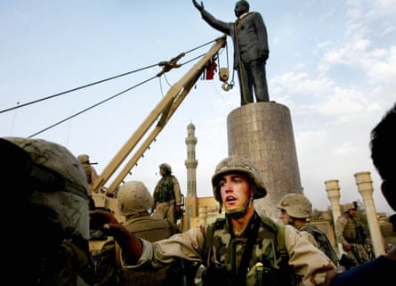 A statue of Saddam in Firdos Square, Baghdad, is pulled down by US marines, April 2003.