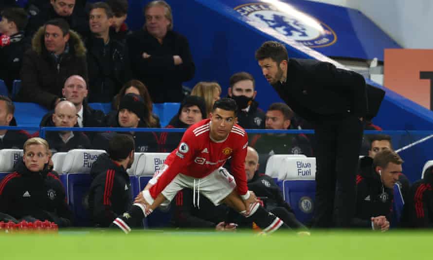 Michael Carrick, right, gives Cristiano Ronaldo instructions before coming on.