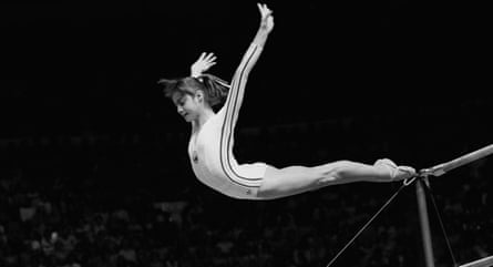 Nadia Comaneci dismounts from the uneven parallel bars during her perfect 10.0 performance at the 1976 Montreal Olympic Games