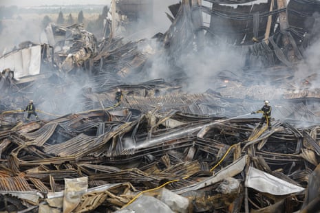 Rescuers work at the site of a Russian missile strike on a goods storage in Kyiv on Wednesday.