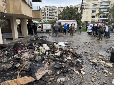 क्षतिग्रस्त इमारत के सामने ज़मीन पर बिखरा हुआ मलबा