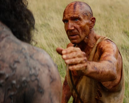 A sweaty, dirty man reaches to embrace a man infected with a zombie-esque disease
