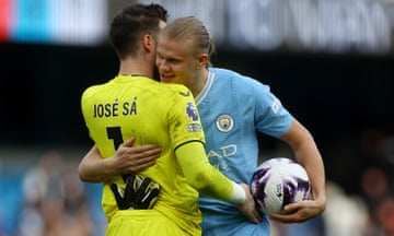 Manchester City's Erling Haaland clutches the match ball as he embraces Wolverhampton Wanderers' keeper Jose Sa after the final whistle.
