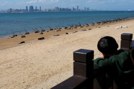 A child looks out over the coastal defences of Kinmen, Taiwan, towards China’s Xiamen city.