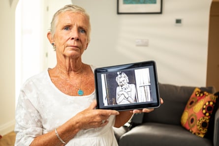 Hyde holds up a framed black-and-white portrait of a blond girl