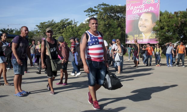 Cuban migrants walk toward the Costa Rican border after riot polices fired teargas at the border between Nicaragua and Costa Rica.