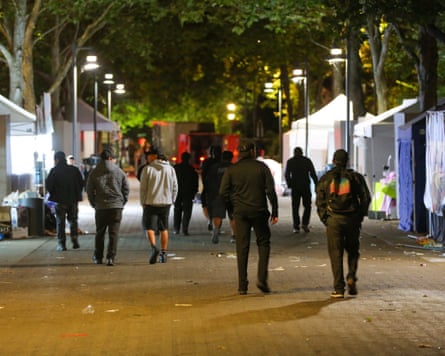 People leave the scene after a fatal shooting during the Bite of Seattle food festival.