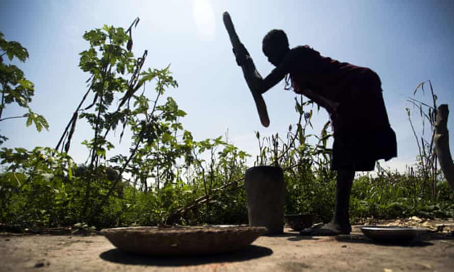 A woman mills sorghum from her family’s land in northern Bahr El-Ghazal in a drought-stricken South Sudan in 2015.