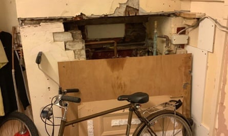 A damaged chimney breast, bike and rubbish