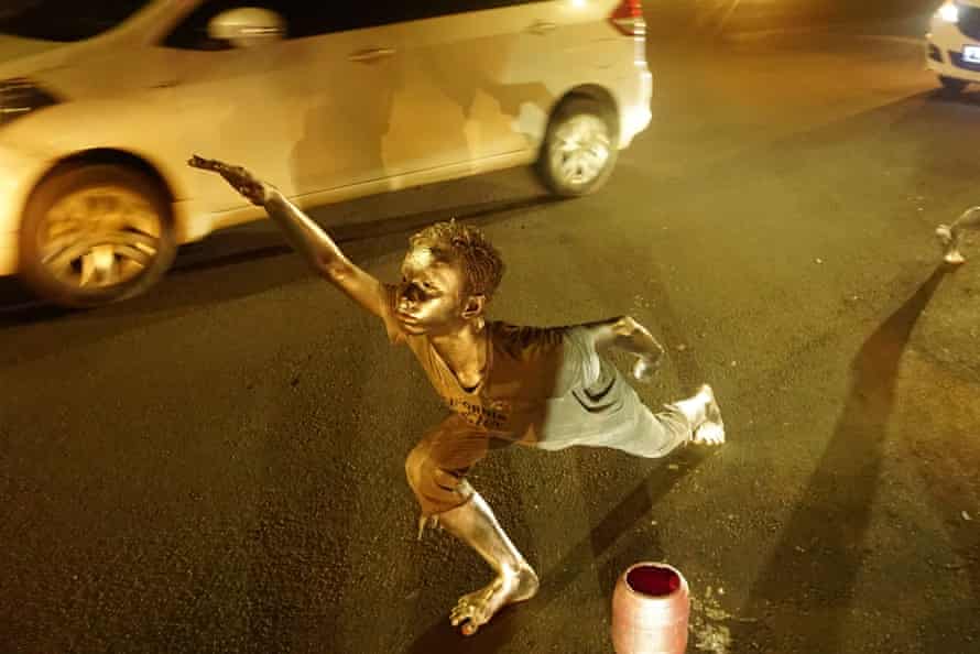 A ‘silverman’ begs for money in Jakarta.