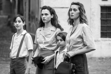 director and star Paola Cortellesi with three younger people playing her children in black and white film There’s Still Tomorrow.