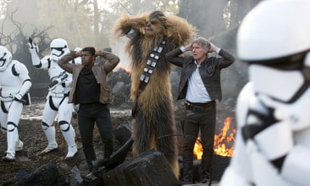 From left: John Boyega, Peter Mayhew (as Chewbacca) and Harrison Ford in Star Wars: The Force Awakens.