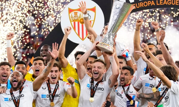 Sevilla’s Ivan Rakitic lifts the Europa League trophy after his team’s victory on penalties over Roma.