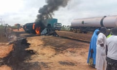 Flames and smoke billowing from a fuel tanker that exploded after colliding with a truck carrying passengers and cattle on a route in Niger state's Agaie local government district on September 8, 2024.