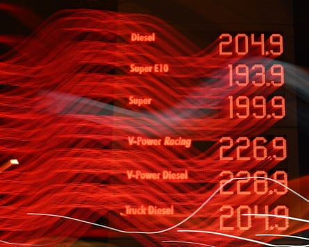 An illuminated display showing prices at a petrol station.