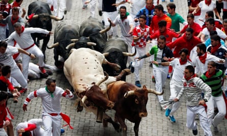 Bulls charge through the streets of Pamplona on the last day of the annual San Fermín festival