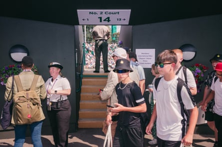 Visitors to Wimbledon pass one of the entrances to No 2 court