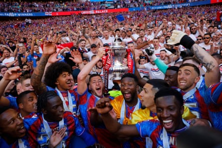Crystal Palace players celebrate with the FA Cup trophy in front of their fans during the Emirates FA Cup Final match between Crystal Palace and Manchester City at Wembley Stadium.