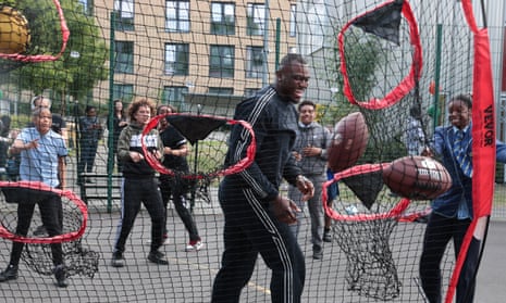 Efe Obada, NFL American football player, on a visit to  Roundwood Youth Centre in Harlesden, north London.