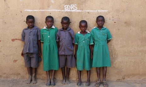Eight year olds in Monze District, Zambia beneath a chalk line indicating the global average height for their age. 40% of children in Zambia suffer from stunted growth, the 10th highest rate in Africa.