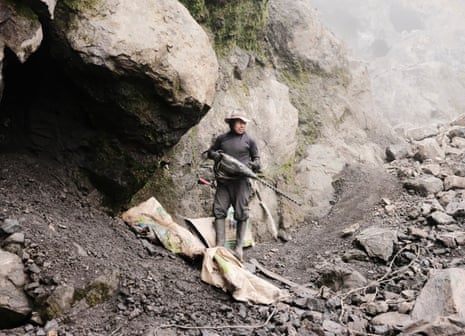 A man standing at the entrance to a mine