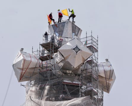 Workers assemble the upper part of the tower of Jesus Christ’s cross on to the Sagrada Familia