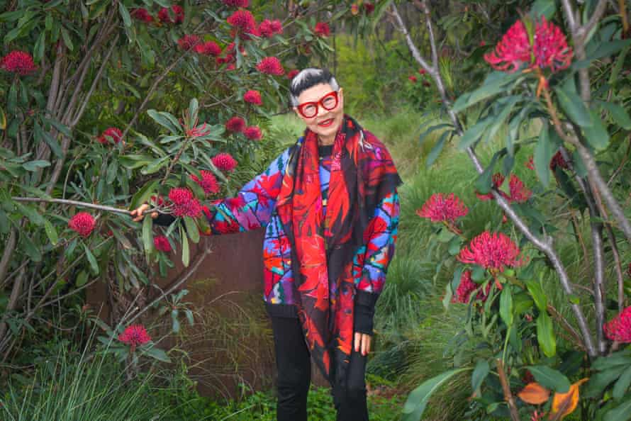Jenny Kee, surrounded by waratahs and wearing her favourite scarf, which bears the angiosperm motif