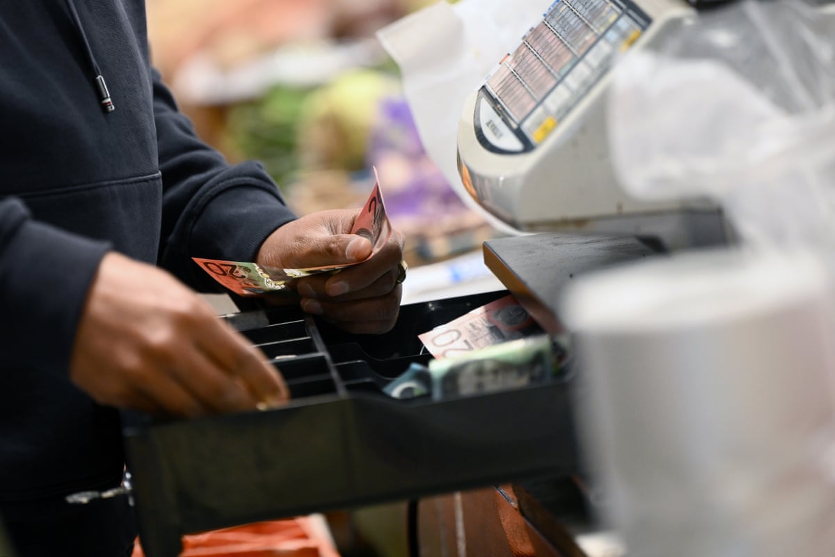 A retail worker at a cash register