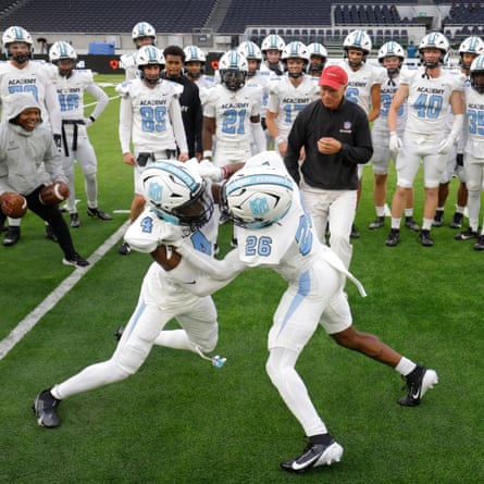 NFL Academy players Thayrancel Pinas (left), a wide reciever from Holland, and Enrique Aspinall, a running back from south London, wrestle with each other watched by teammates and coaches during the warm up before their match against De La Salle Spartans from California at the Tottenham Hotspur Stadium.