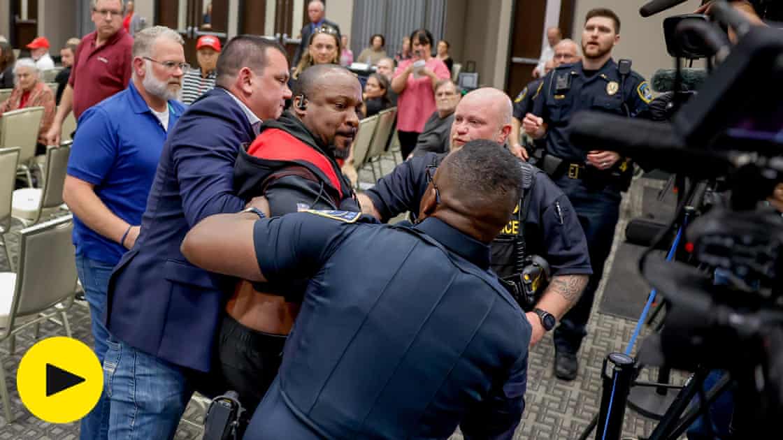 Police use Taser on protester at Marjorie Taylor Greene town hall – video