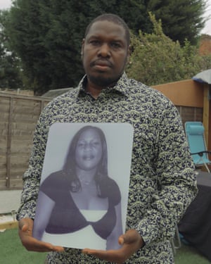 Ken Sazuze holds a portrait of Elsie, his wife of 24 years.
