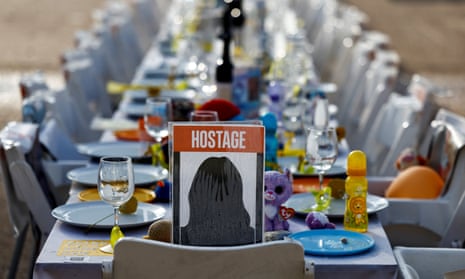 A dinner table to celebrate the Jewish festival of Hanukkah is set with empty chairs that symbolically represent the Israeli hostages who are being held in the Gaza Strip.
