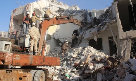 Syrian civil Defence members search for survivors amid rubble following reported air strikes on the city of Idlib.