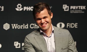 Magnus Carlsen smiles during a press conference after retaining his chess crown.