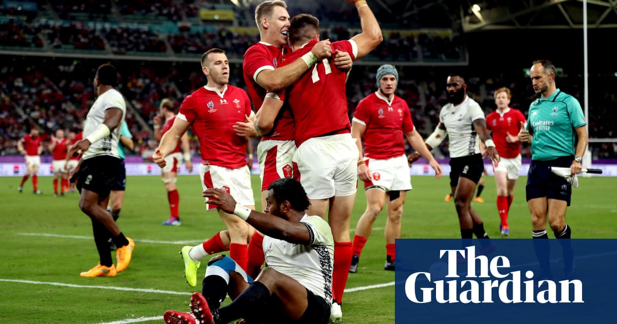 Wales survive major Fiji scare as Josh Adams hat-tricks seals top spot