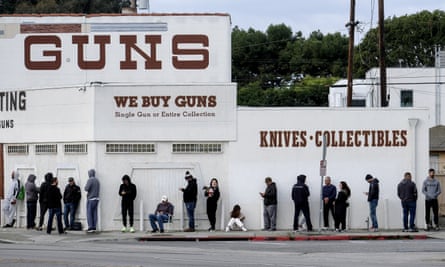People wait in line to enter a gun store in Culver City, California, 15 March 2020.